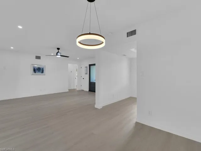 a view of an empty room with glass door