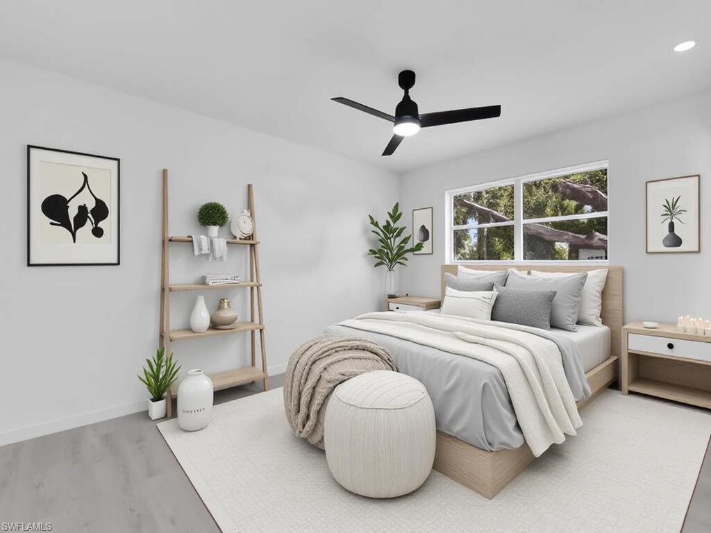 4941 Aztec Circle Naples, FL 34112 - Photo 16 of 36 a bedroom with a bed and a large window