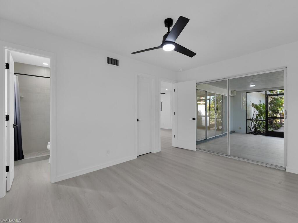 4941 Aztec Circle Naples, FL 34112 - Photo 17 of 36 a view of an empty room with glass door