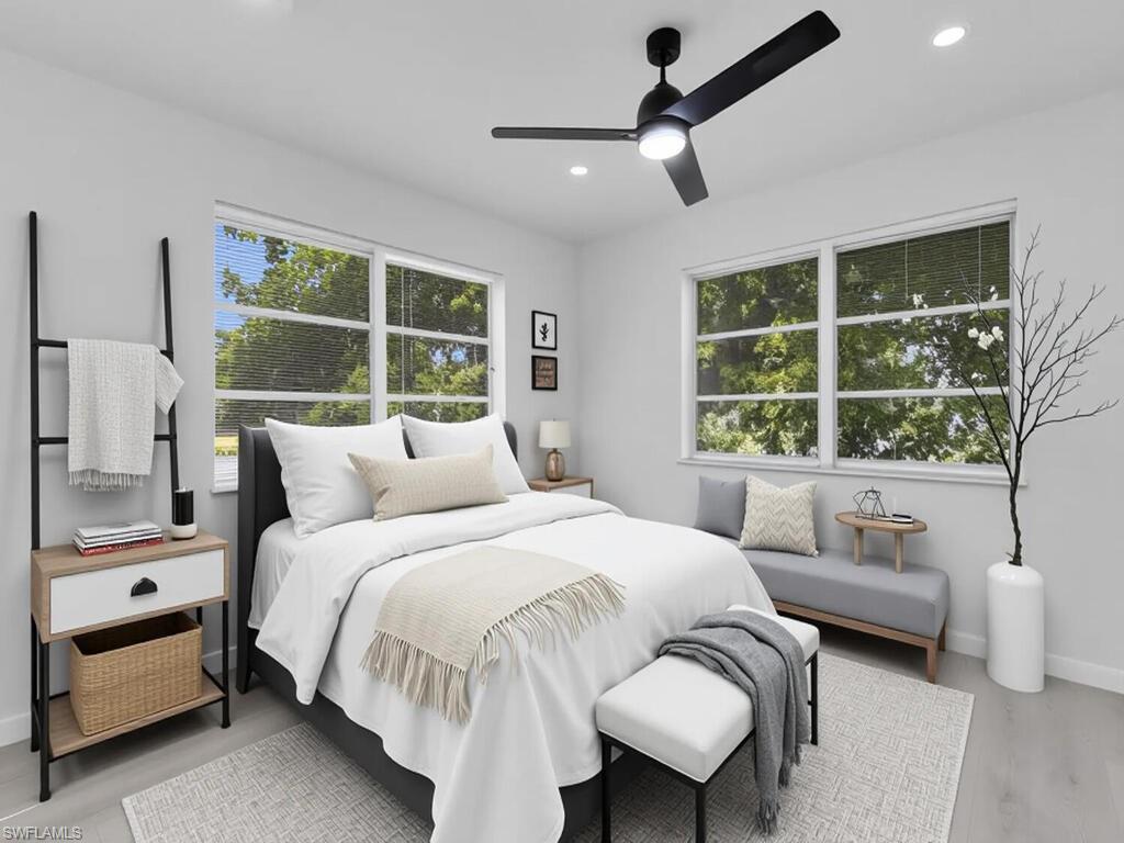 4941 Aztec Circle Naples, FL 34112 - Photo 20 of 36 a bedroom with a bed and a large window