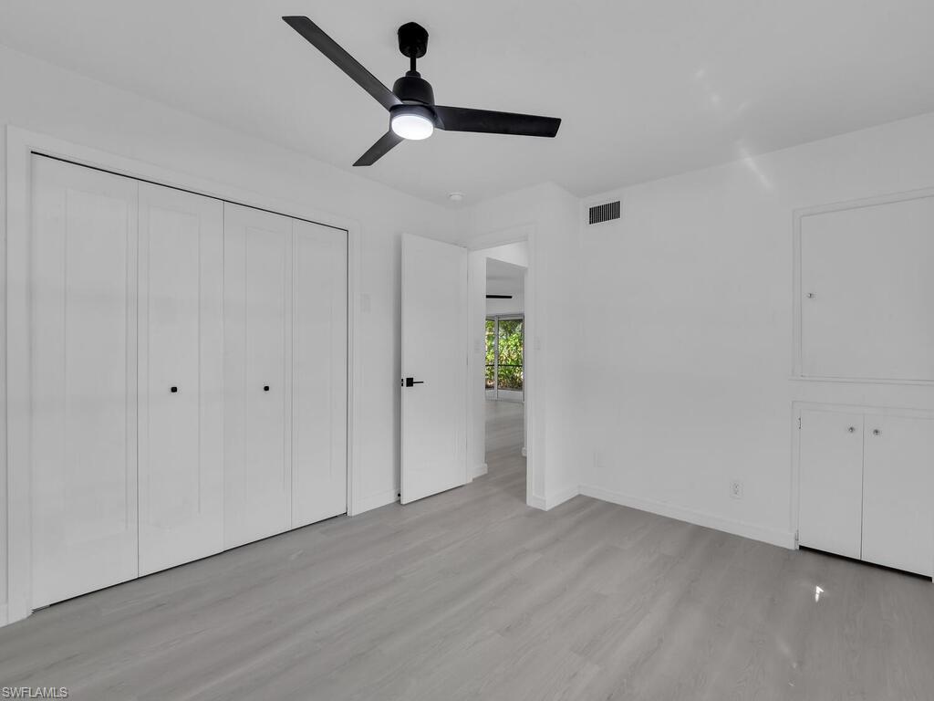 4941 Aztec Circle Naples, FL 34112 - Photo 21 of 36 wooden floor in an empty room