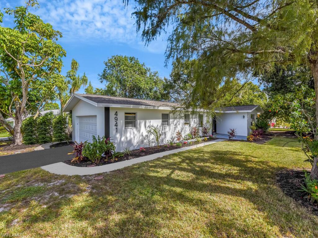 4941 Aztec Circle Naples, FL 34112 - Photo 25 of 36 a front view of house with garden