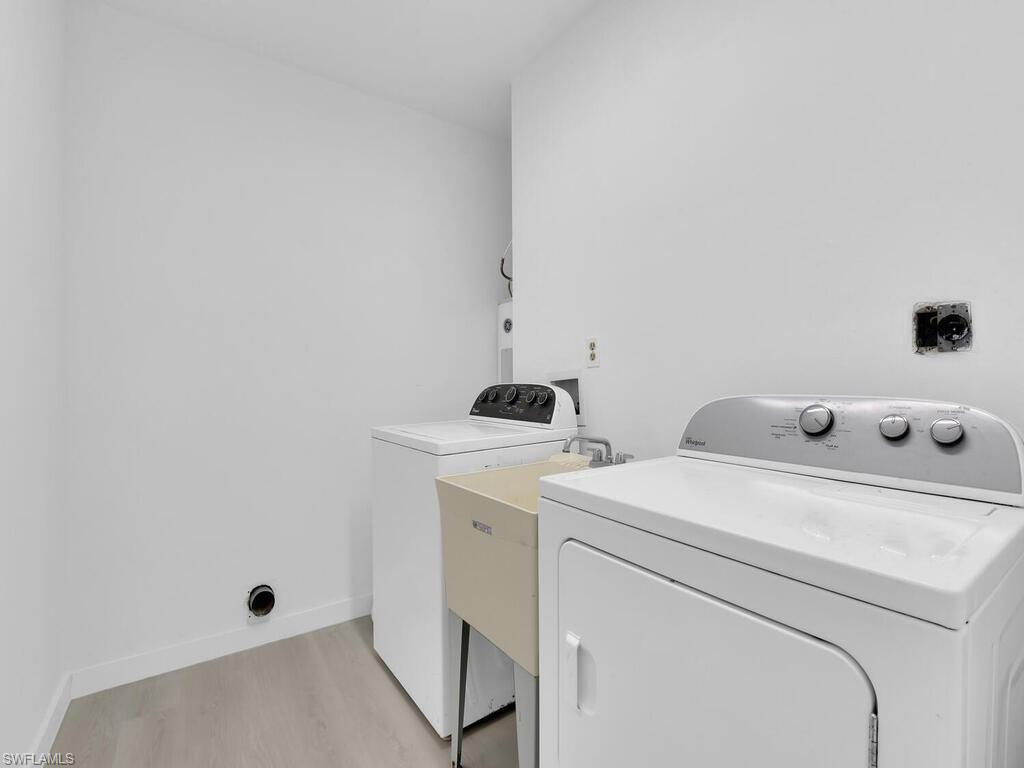 4941 Aztec Circle Naples, FL 34112 - Photo 29 of 36 a utility room with dryer and washer
