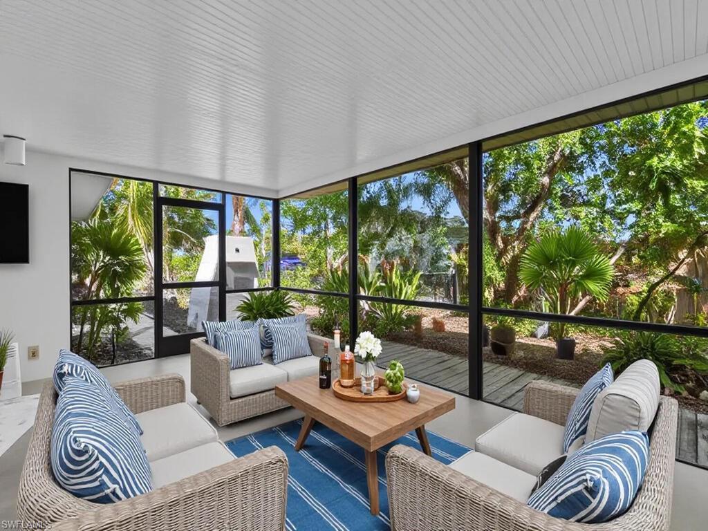 4941 Aztec Circle Naples, FL 34112 - Photo 30 of 36 a living room with furniture and a large window