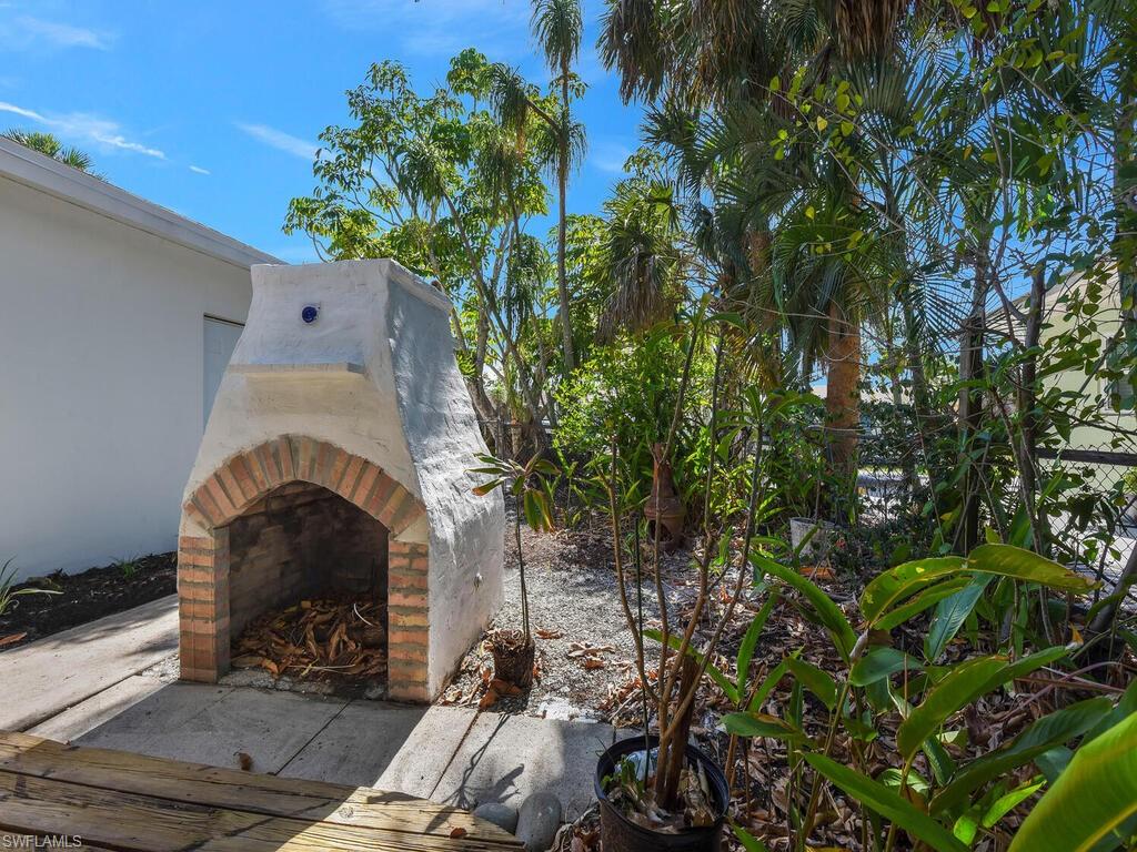 4941 Aztec Circle Naples, FL 34112 - Photo 32 of 36 a front view of a house with a yard