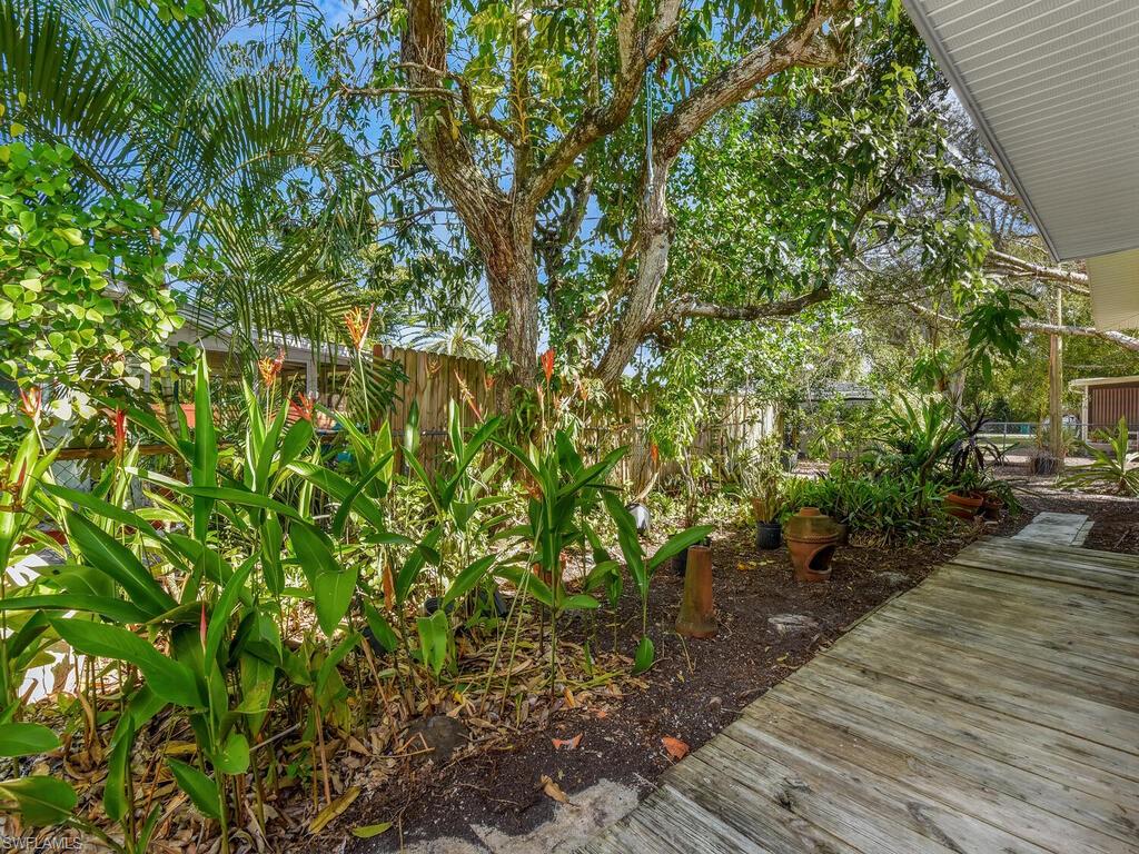 4941 Aztec Circle Naples, FL 34112 - Photo 34 of 36 a backyard of a house with lots of green space
