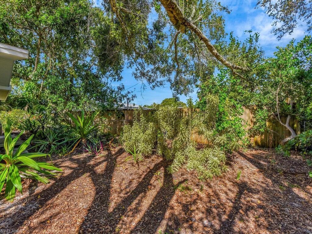 4941 Aztec Circle Naples, FL 34112 - Photo 35 of 36 a view of a forest with trees in the background