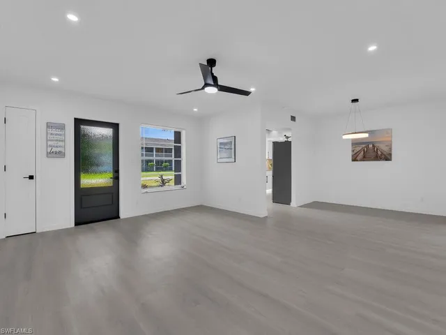 a view of a livingroom with a ceiling fan and window