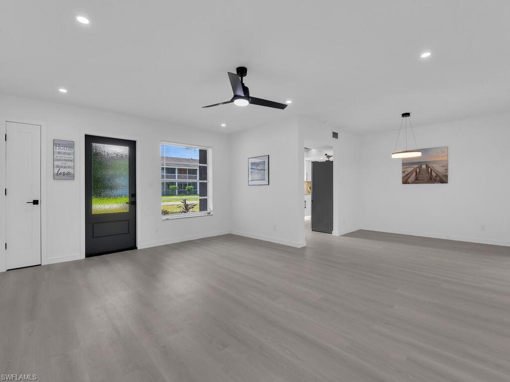 4941 Aztec Circle Naples, FL 34112 - Photo 7 of 36 an empty room with ceiling fan and windows