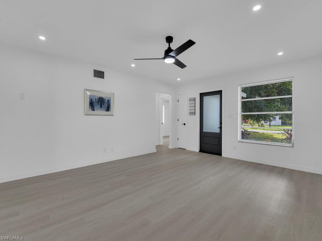 4941 Aztec Circle Naples, FL 34112 - Photo 8 of 36 a view of a livingroom with a ceiling fan and window
