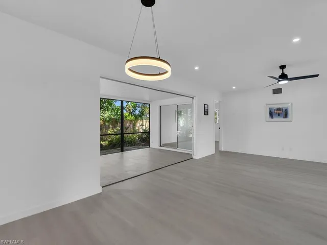a kitchen with white cabinets stainless steel appliances and sink