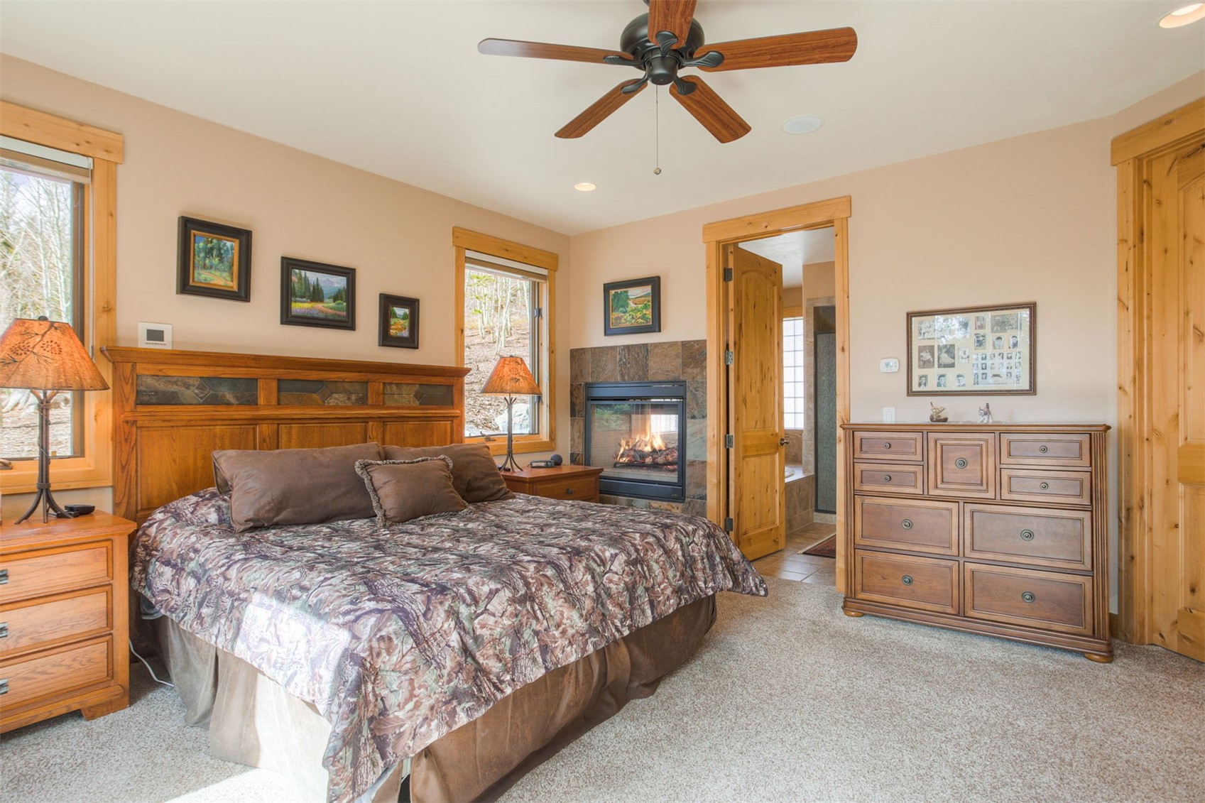 727 Willowbrook Road Silverthorne, CO 80498 - Photo 24 of 47 a bedroom with a large bed and a chandelier