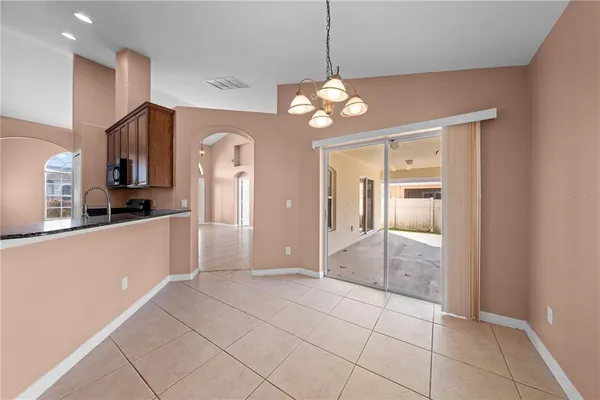 a view of a kitchen with a refrigerator and microwave