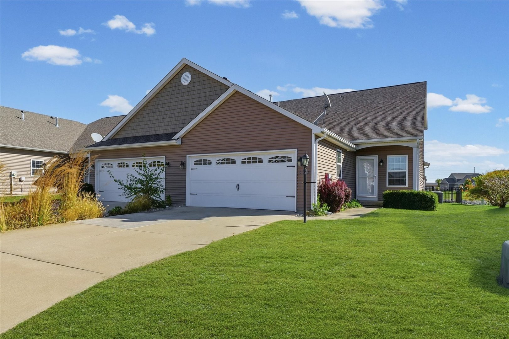 a front view of a house with a yard and garage