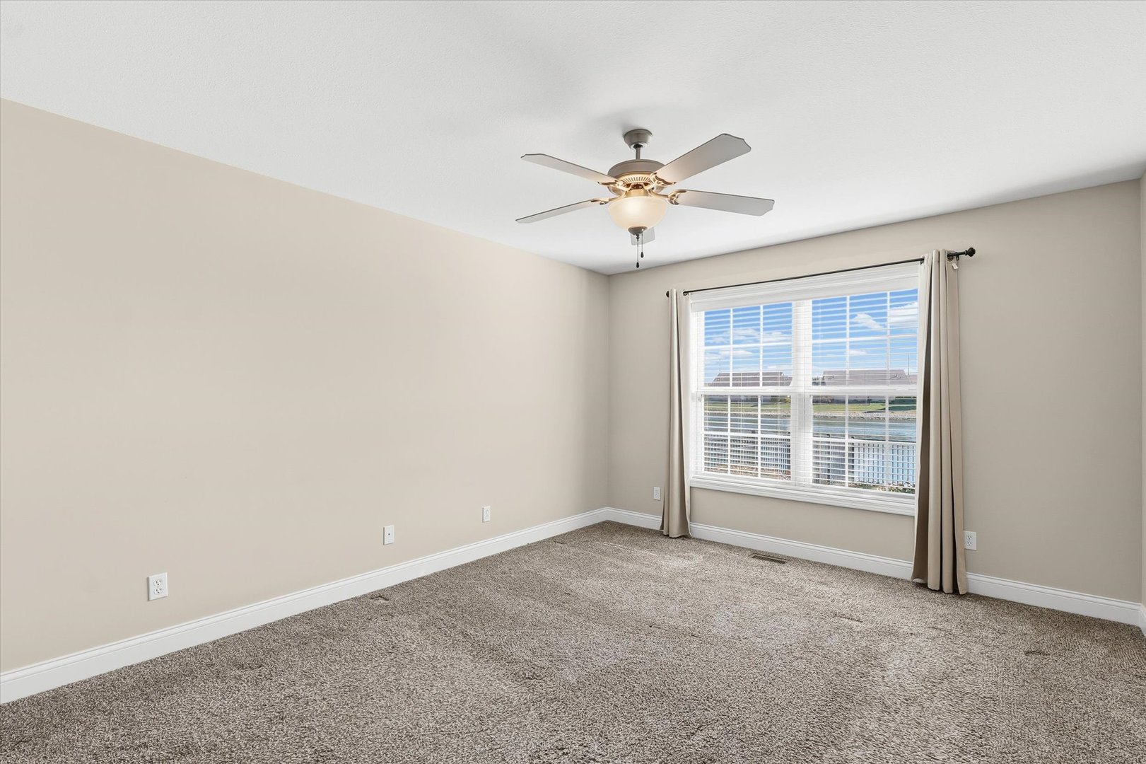 2208 Cyprus Point, Unit 2208 Urbana, IL 61802 - Photo 15 of 30 an empty room with a window and a ceiling fan