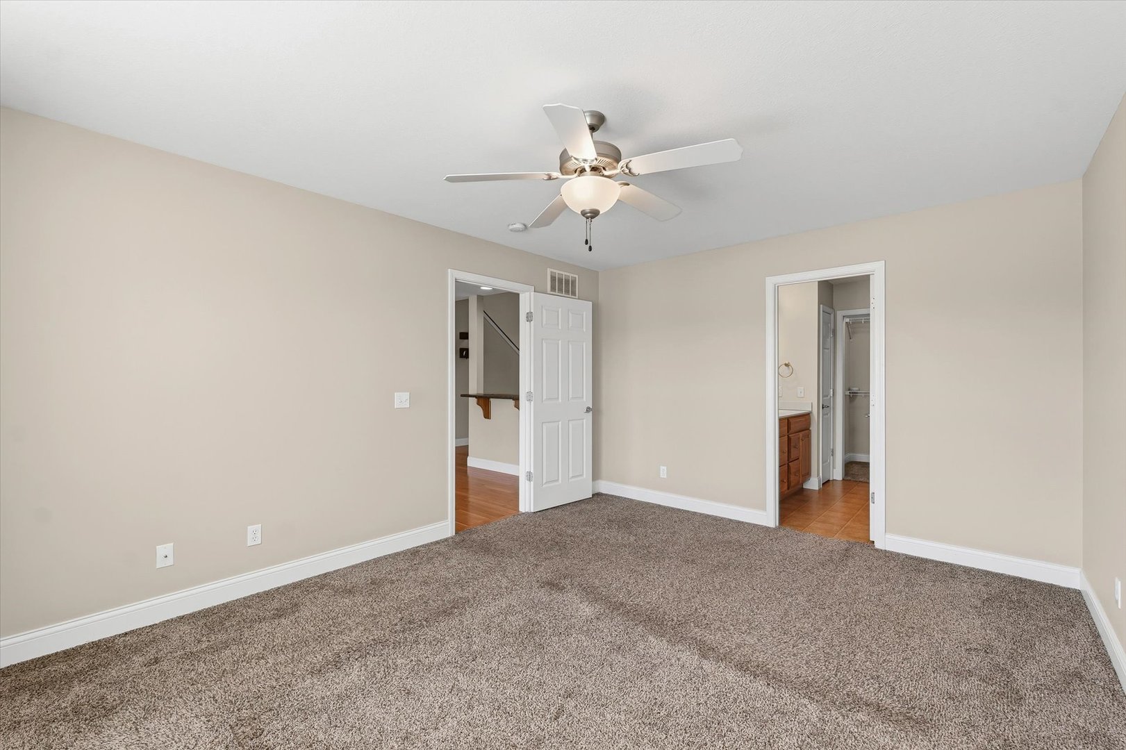 2208 Cyprus Point, Unit 2208 Urbana, IL 61802 - Photo 16 of 30 a view of an empty room with a ceiling fan