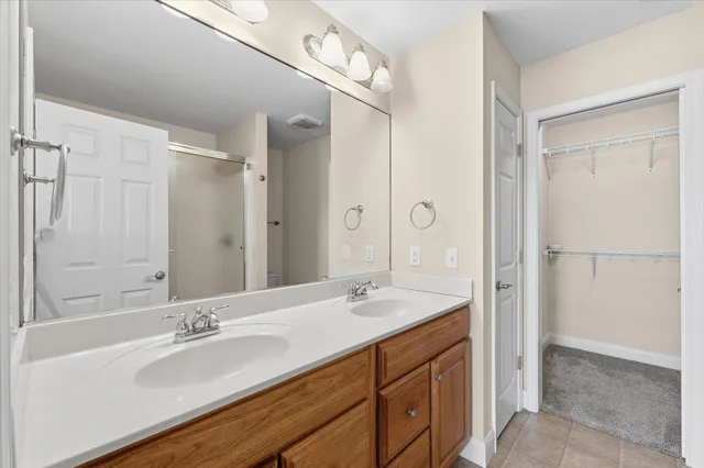 a bathroom with a tub sink double and mirror