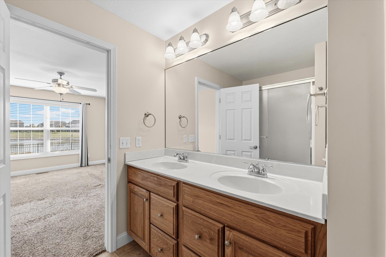 2208 Cyprus Point, Unit 2208 Urbana, IL 61802 - Photo 18 of 30 a bathroom with a sink double vanity and a mirror