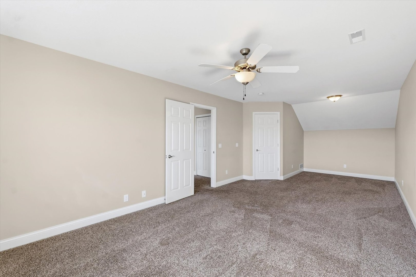 2208 Cyprus Point, Unit 2208 Urbana, IL 61802 - Photo 22 of 30 an empty room with a fan & a ceiling fan