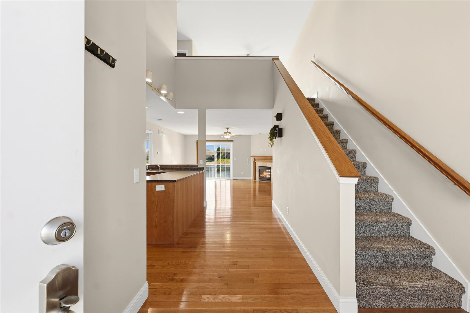 2208 Cyprus Point, Unit 2208 Urbana, IL 61802 - Photo 4 of 30 a view of a hallway with wooden floor and staircase