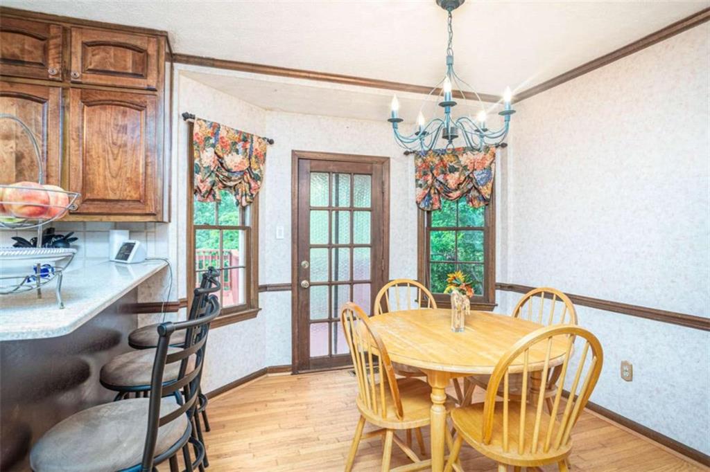 3838 Hunting Ridge Drive Southwest Lilburn, GA 30047 - Photo 19 of 56 a view of a dining room with furniture window and outside view