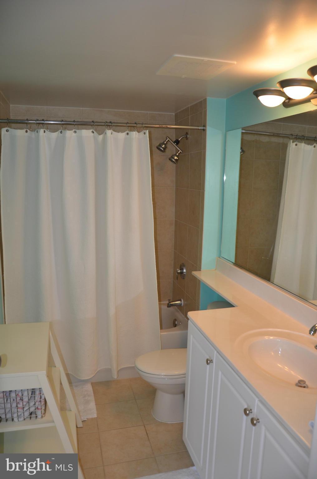 851 North Glebe Road, Unit 1116 Arlington, VA 22203 - Photo 16 of 30 a bathroom with a granite countertop sink toilet and shower