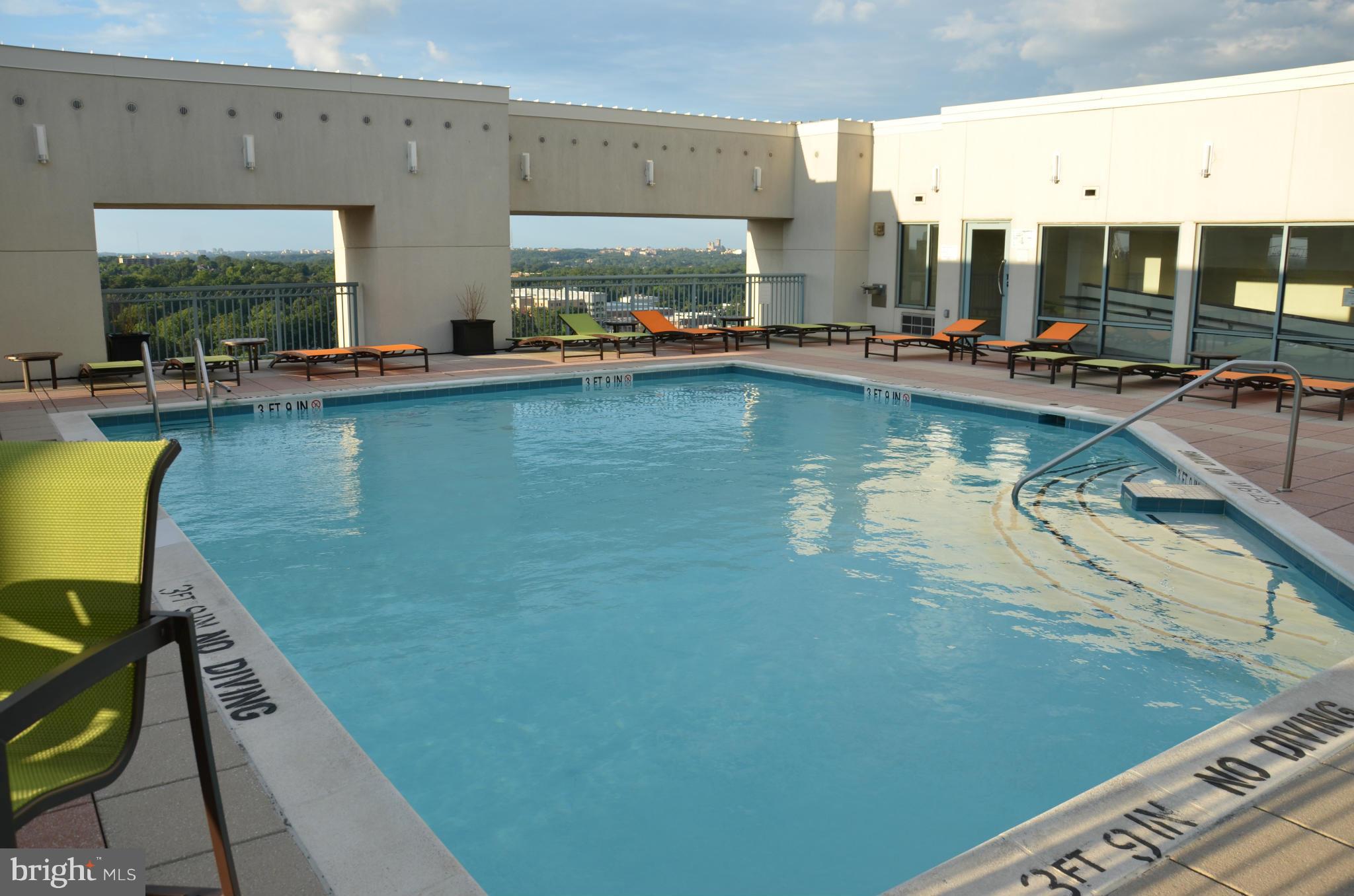 851 North Glebe Road, Unit 1116 Arlington, VA 22203 - Photo 18 of 30 a view of a swimming pool with chairs