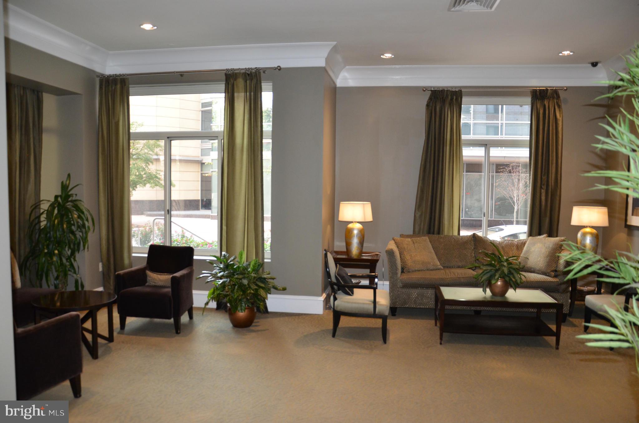 851 North Glebe Road, Unit 1116 Arlington, VA 22203 - Photo 3 of 30 a living room with furniture and a large window