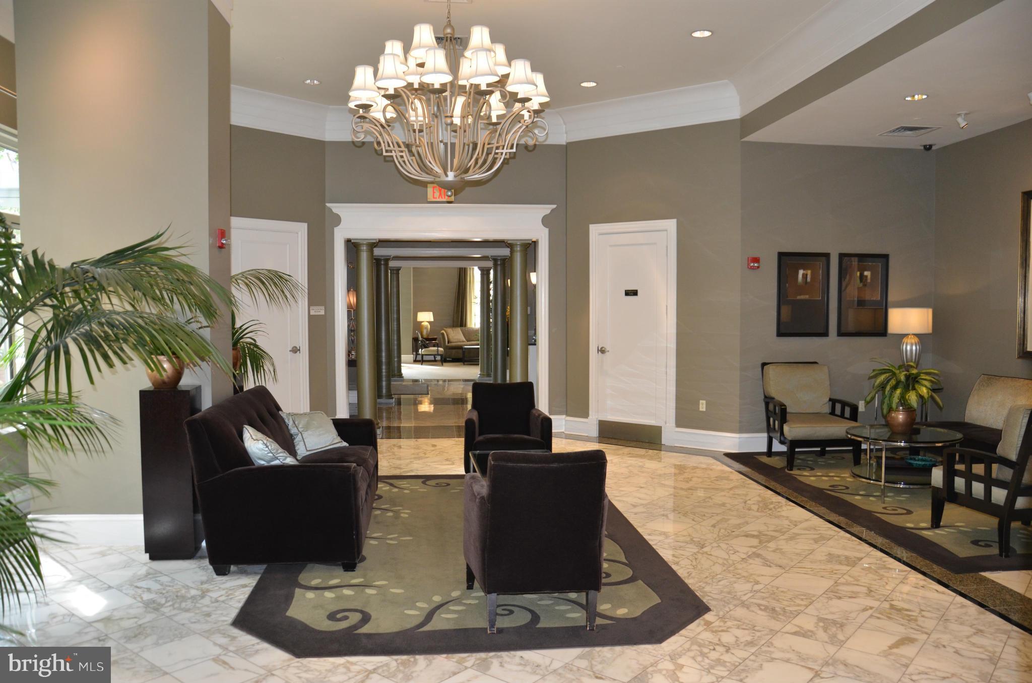 851 North Glebe Road, Unit 1116 Arlington, VA 22203 - Photo 7 of 30 a living room with furniture and a chandelier