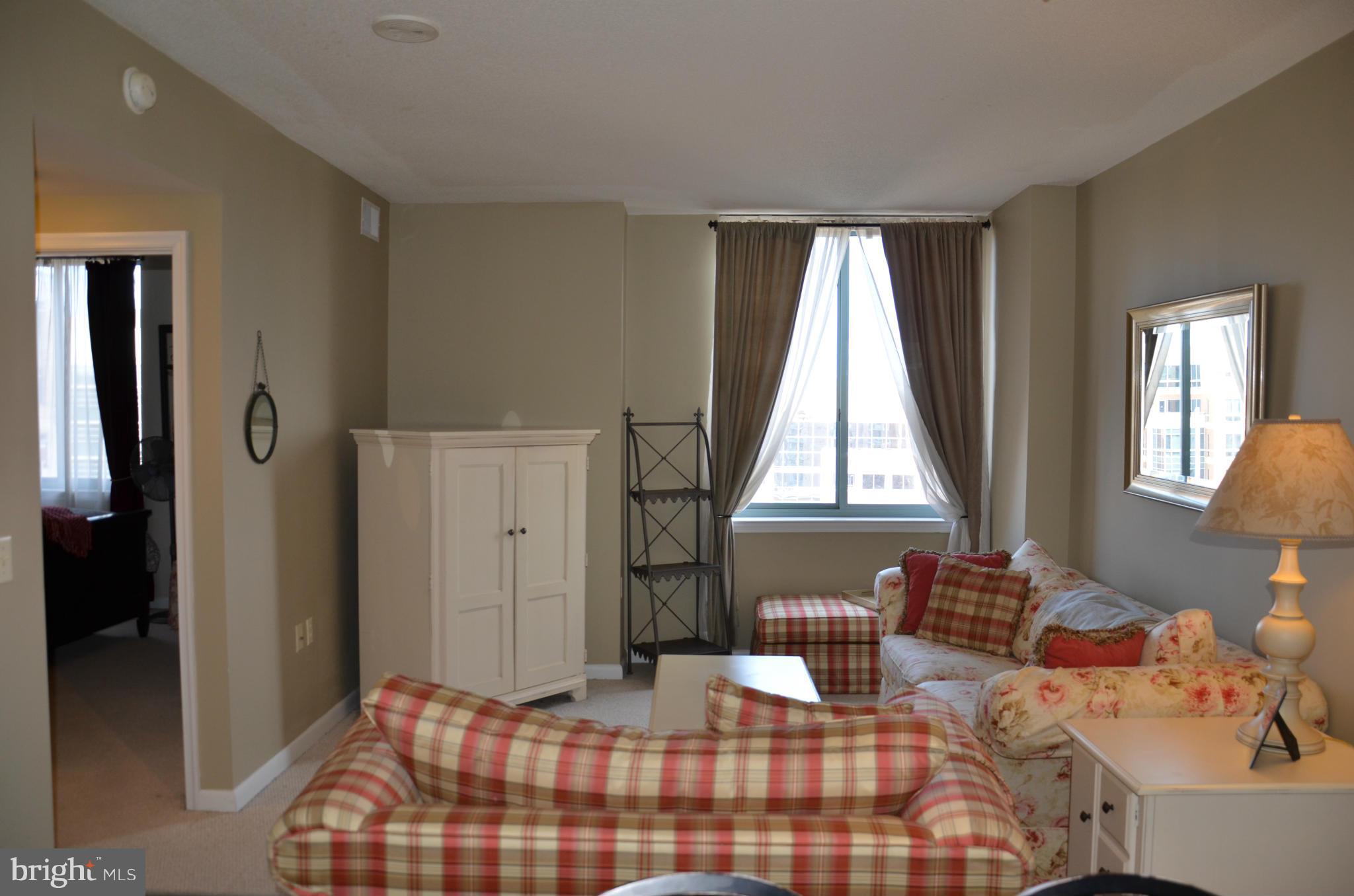 851 North Glebe Road, Unit 1116 Arlington, VA 22203 - Photo 9 of 30 a bedroom with a bed and wooden floor