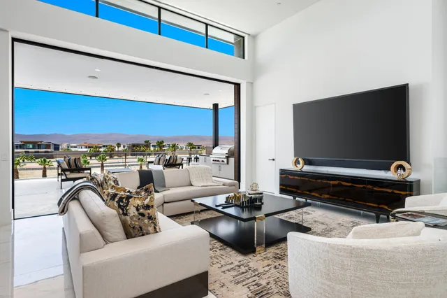 a living room with furniture and large window