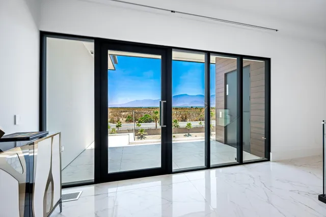 a bedroom with a large bed and a flat screen tv
