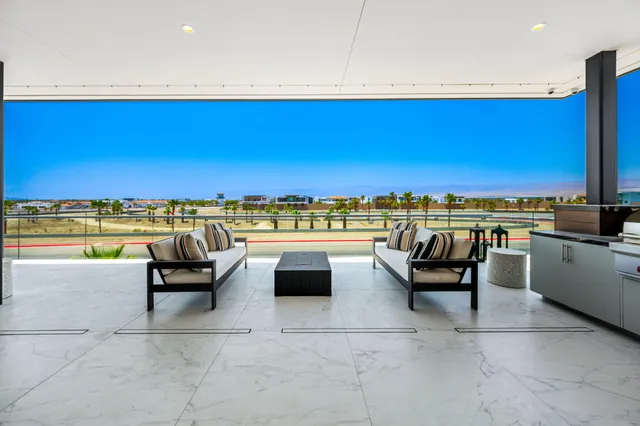 a view of a swimming pool and lounge chairs