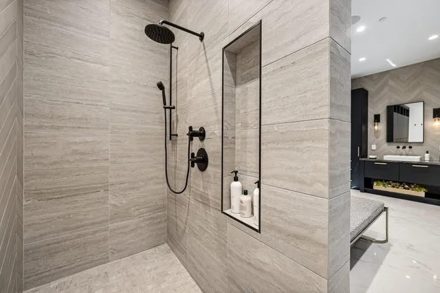 a bedroom with a large bed and a chandelier