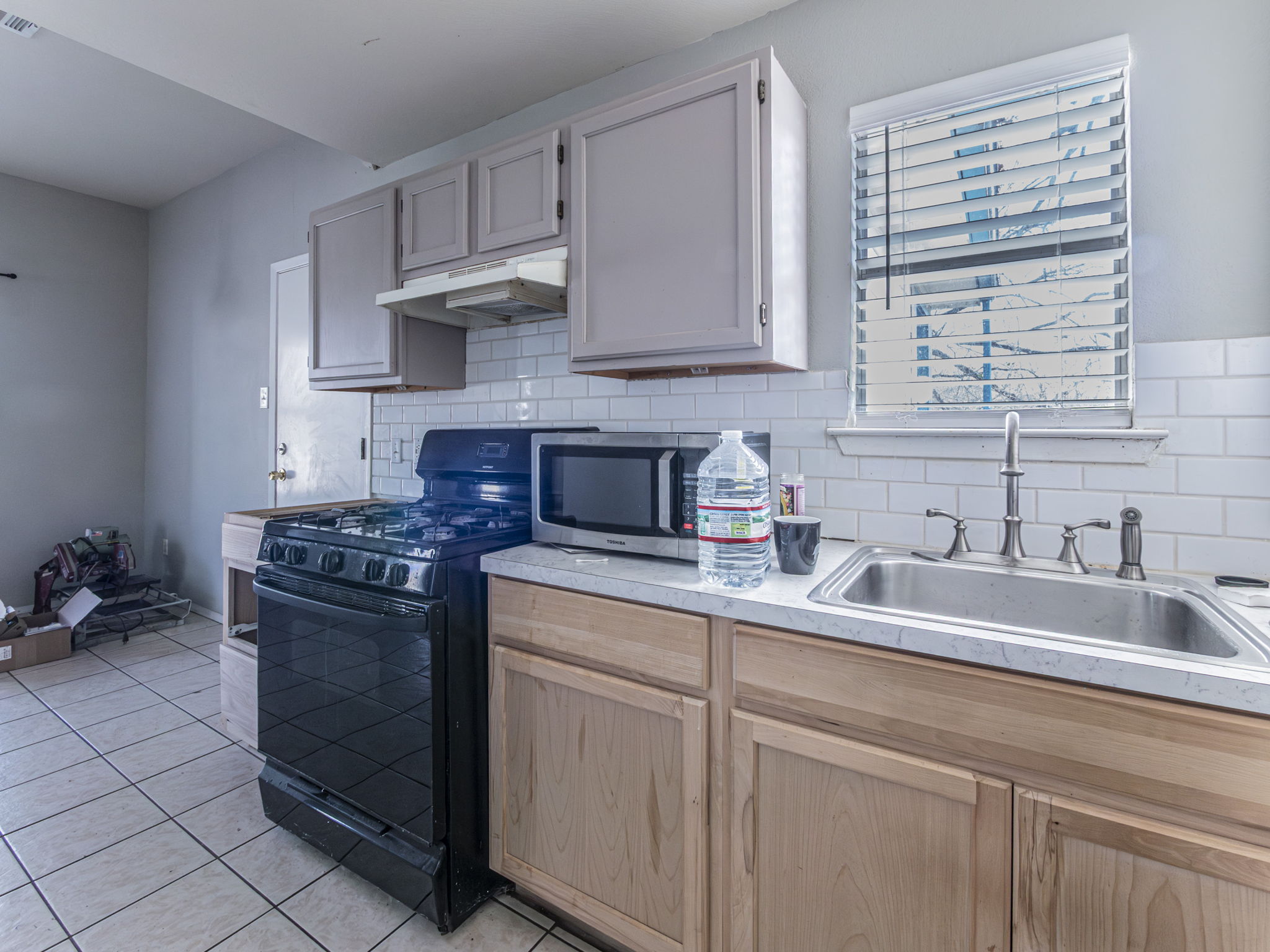 909 West Rundberg Lane Austin, TX 78758 - Photo 7 of 16 a kitchen with stainless steel appliances granite countertop a sink stove and cabinets