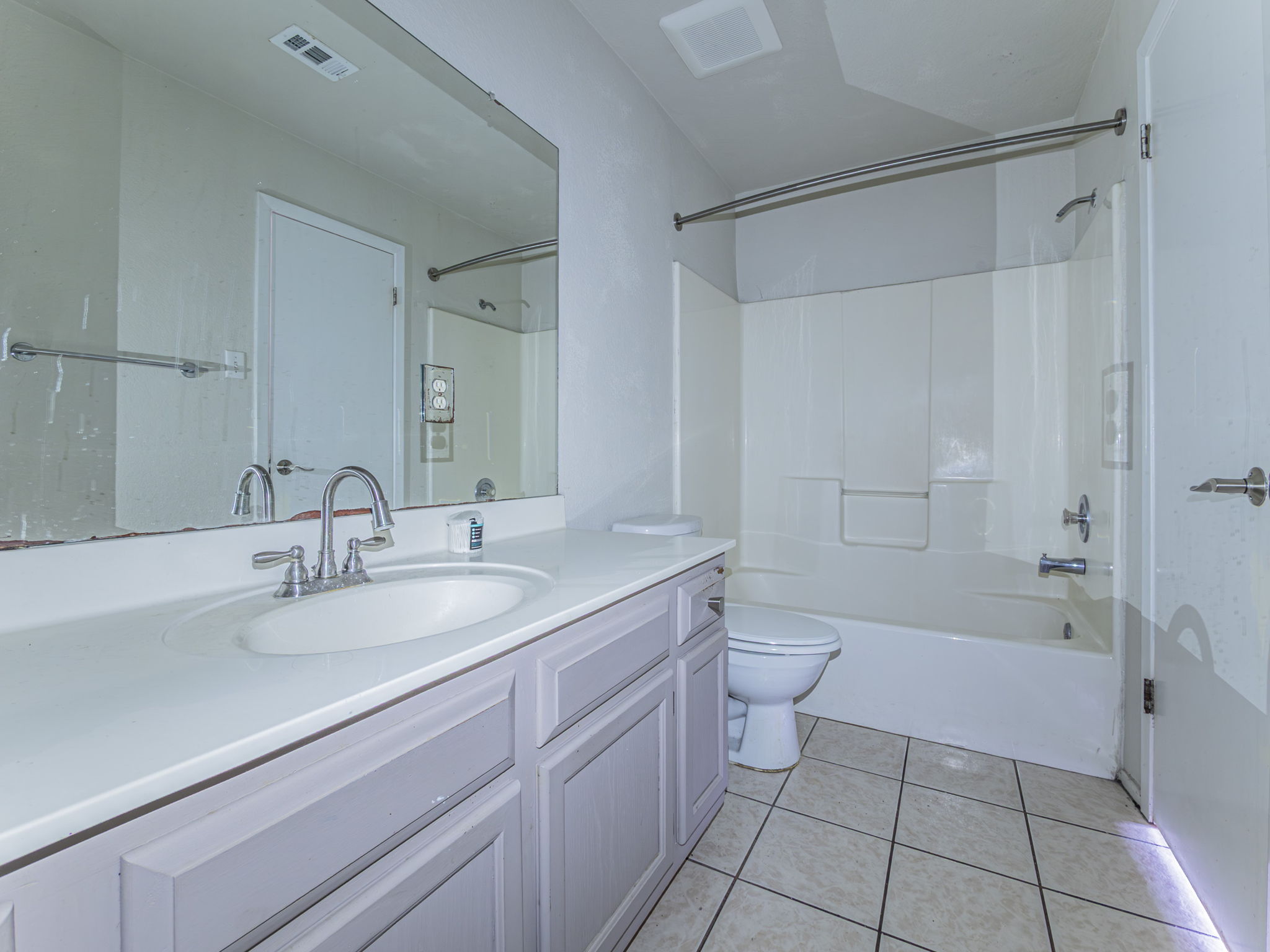 909 West Rundberg Lane Austin, TX 78758 - Photo 10 of 16 a bathroom with a granite countertop sink a toilet and a bathtub