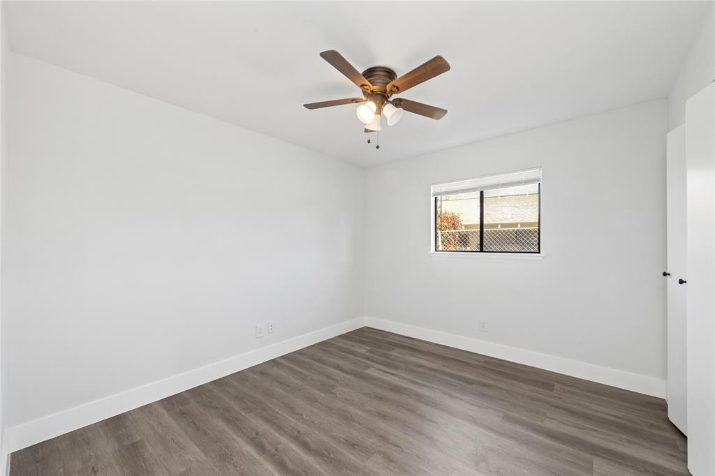 2119 Meadfoot Road Carrollton, TX 75007 - Photo 20 of 30 Unfurnished room with dark wood-style flooring and a ceiling fan