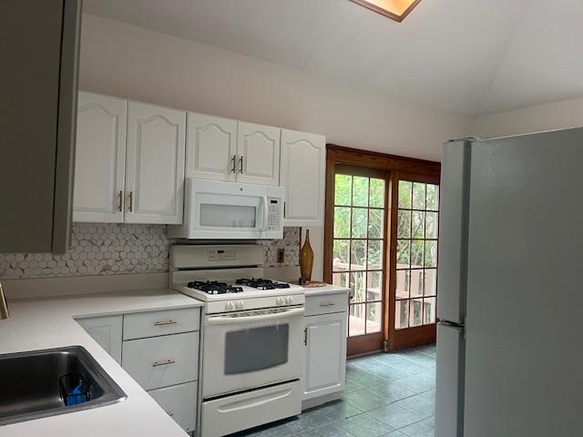 85-33 112th Street Queens, NY 11418 - Photo 2 of 15 a kitchen with granite countertop white cabinets and white appliances