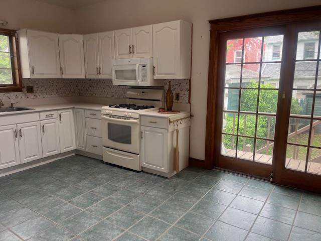 85-33 112th Street Queens, NY 11418 - Photo 3 of 15 a kitchen with a stove a sink and a refrigerator