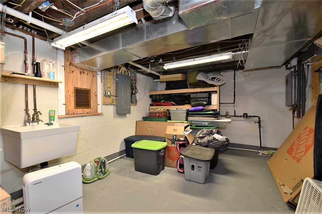 8790 Avery Road Broadview Heights, OH 44147 - Photo 30 of 35 The utility room has plenty of storage and access to the crawlspace under the addition. This home features a tankless water heater for on-demand hot water for those chilly days when you linger in the luxury shower.