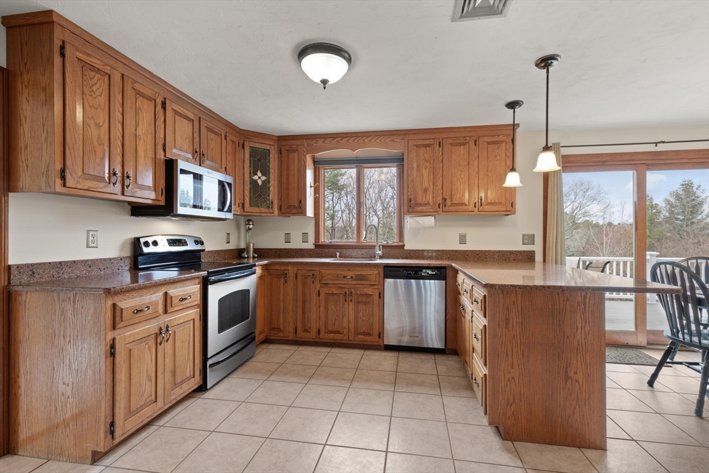 3 Daniels Road Mendon, MA 01756 - Photo 12 of 42 a kitchen with stainless steel appliances granite countertop a stove top oven a sink a counter top space and cabinets