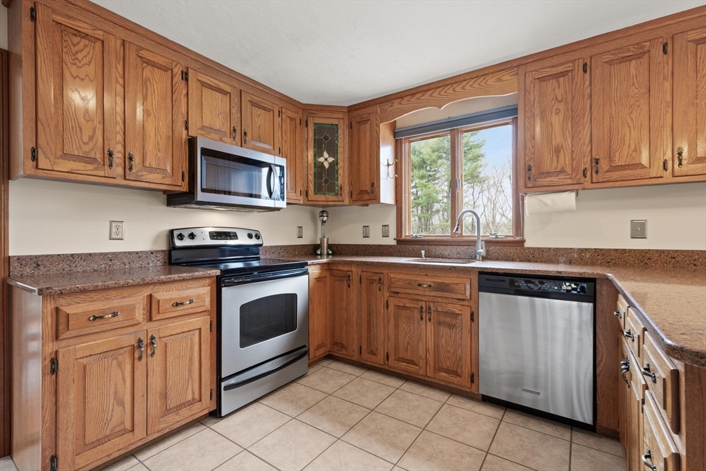 3 Daniels Road Mendon, MA 01756 - Photo 13 of 42 a kitchen with granite countertop cabinets stainless steel appliances a sink and window