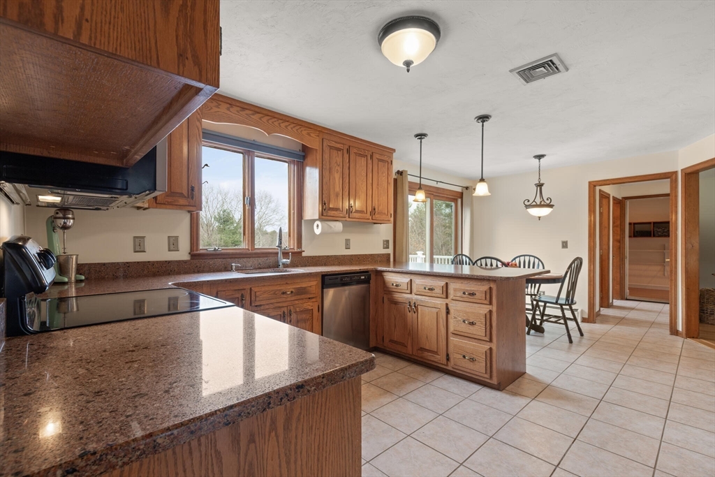 3 Daniels Road Mendon, MA 01756 - Photo 14 of 42 a large kitchen with kitchen island a large counter space a sink a window and stainless steel appliances