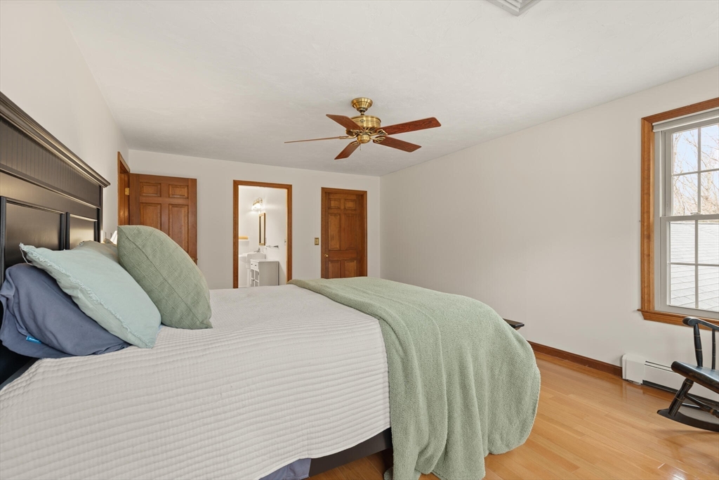 3 Daniels Road Mendon, MA 01756 - Photo 24 of 42 a bedroom with a bed and a chandelier