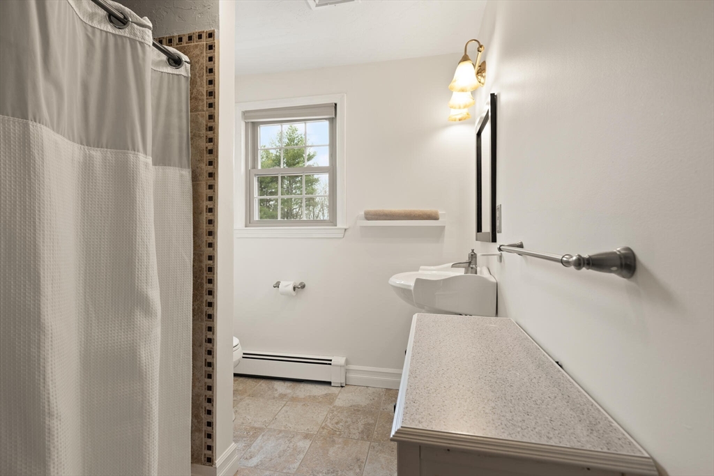 3 Daniels Road Mendon, MA 01756 - Photo 25 of 42 a bathroom with a tub and a window