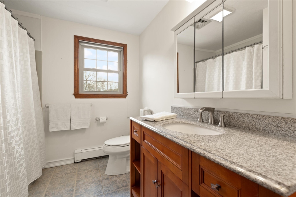 3 Daniels Road Mendon, MA 01756 - Photo 29 of 42 a bathroom with a granite countertop sink a toilet and a mirror
