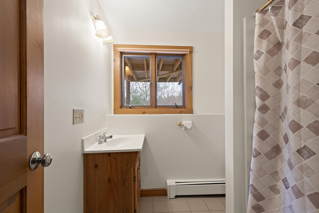 3 Daniels Road Mendon, MA 01756 - Photo 32 of 42 a bathroom with a sink and a mirror