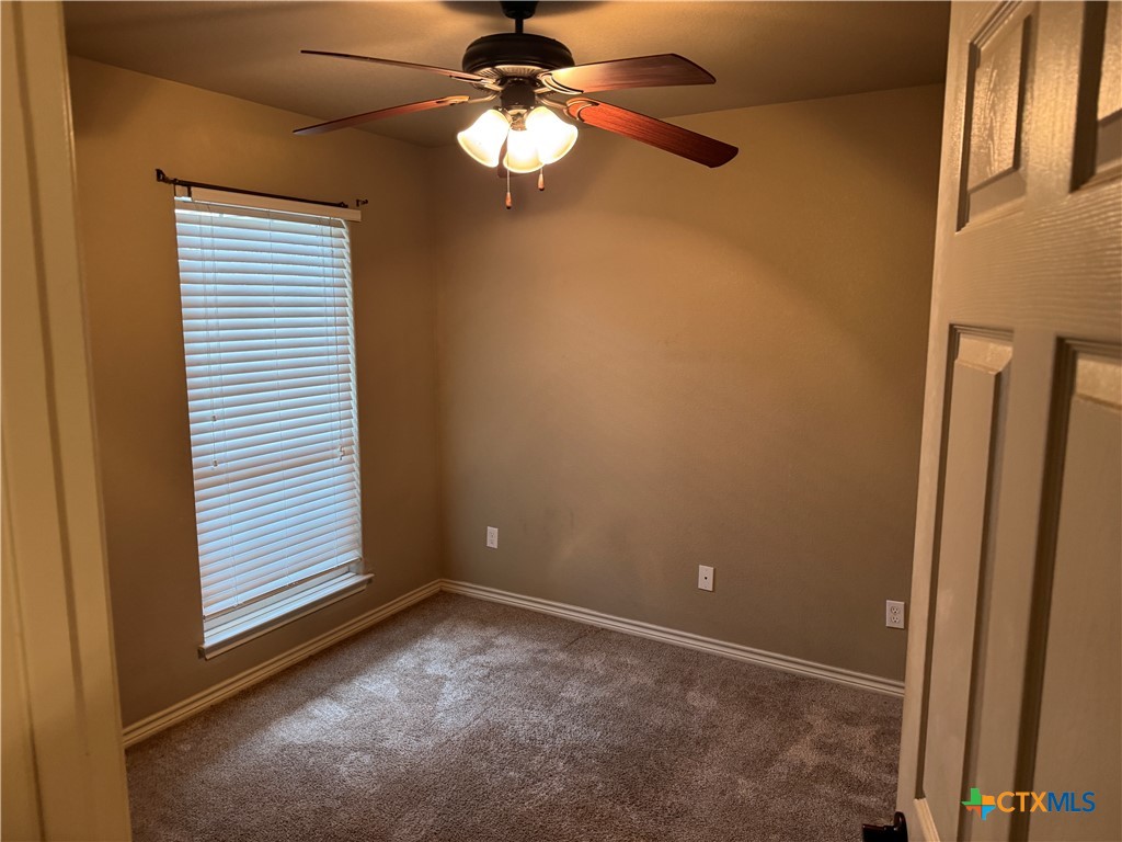 8811 Key Stone Temple, TX 76502 - Photo 11 of 22 en empty room with windows and ceiling fan