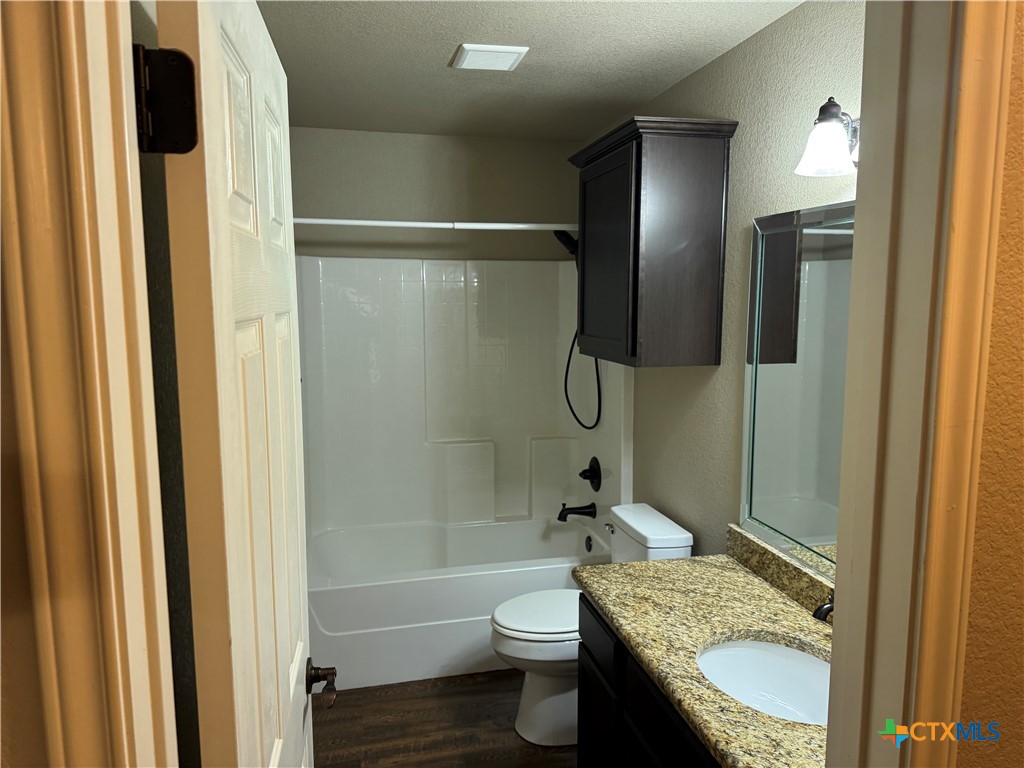 8811 Key Stone Temple, TX 76502 - Photo 10 of 22 a bathroom with a granite countertop toilet sink and shower