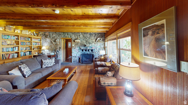315 Abbey Road Moab, UT 84532 - Photo 41 of 46 Living area featuring a stone fireplace, hardwood / wood-style floors, and a wooden ceiling with exposed beams